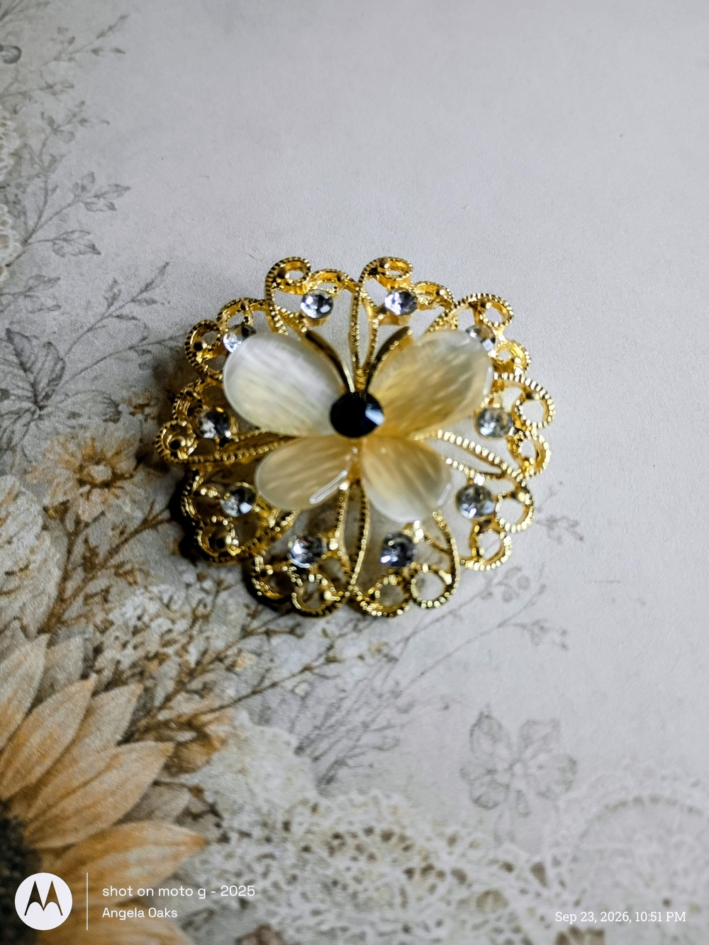 Gold-Tone Floral Brooch with Cream Petals and Crystal Accents